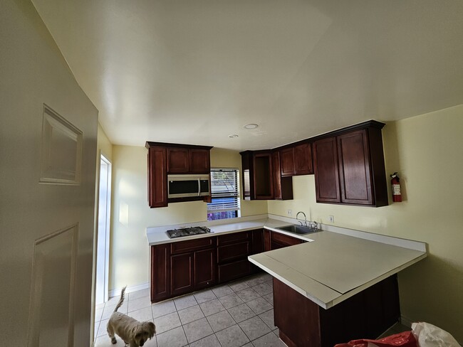 Gas burner stove, microwave, extra cabin space, and breakfast bar - 1030 Aldgate Ave Apartments