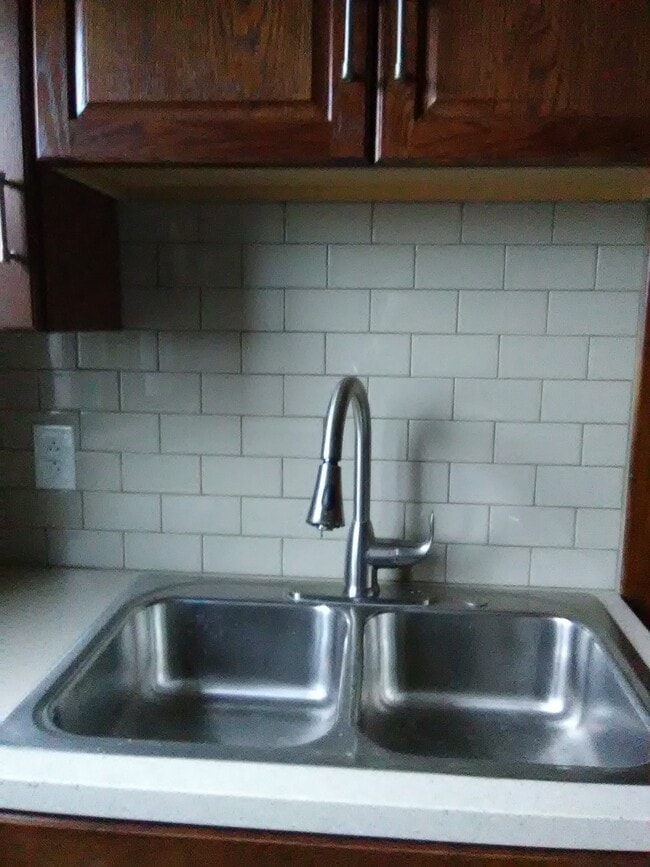 newly renovated kitchen with new cupboards, tile and stainless steel appliances - 3210 Main St Unit Apartment 1
