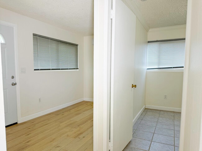 (B) Front entry room on left, bedroom on right, standing in door to kitchen - 1722 E Victoria Ave