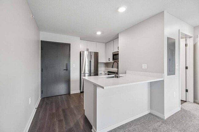 A sleek breakfast bar and contemporary finishes create a welcoming space that effortlessly connects cooking, dining, and everyday living.