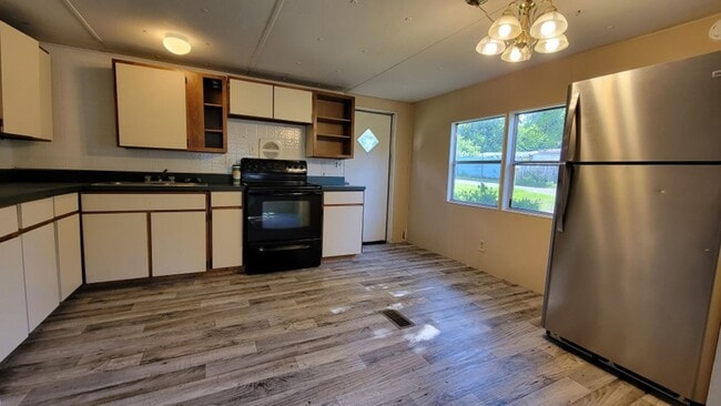 Photo - Freshly painted spacious 2-bedroom 1-bath home with a screened porch and storage shed.