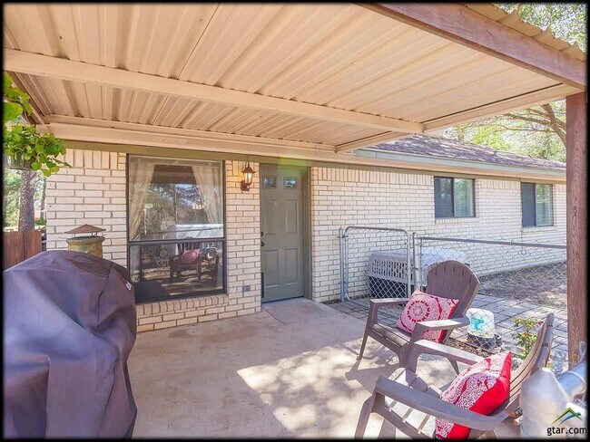 this is covered backyard patio. a new door was added to the right this is not the entrance. - 16608 Echo Glen Dr