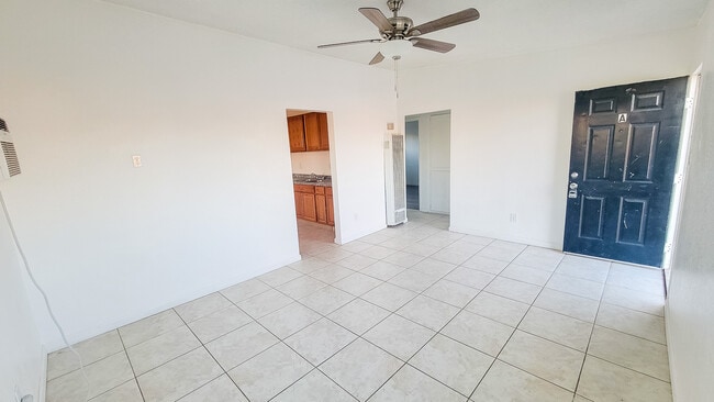 Living room with ceiling fan and natural light - 5527 Baileya Ave Unit A