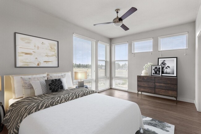 Corner windows on two walls keep the bedroom bright all afternoon.