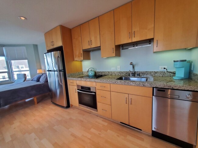 Building Photo - Downtown High-Rise Studio with parking and in-home laundry