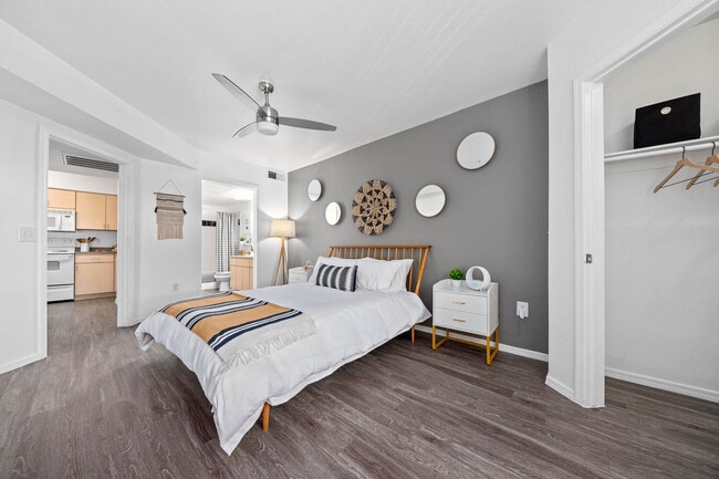 Bedroom with gray accent wall, decorative wall plates and wood-frame bed