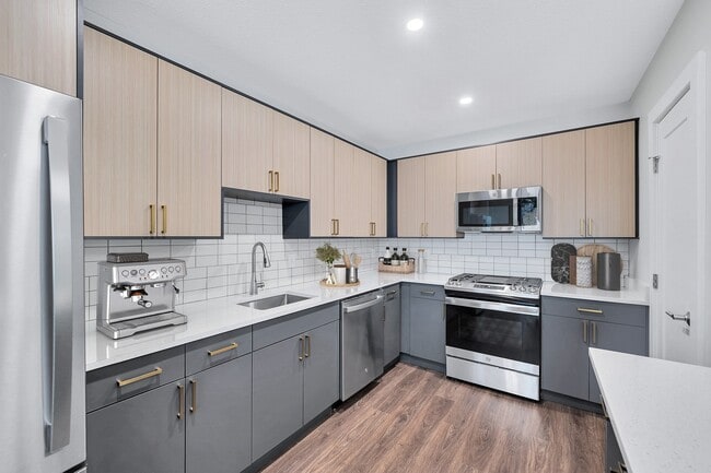 Gourmet designer kitchens with tile backsplash and gold finishes