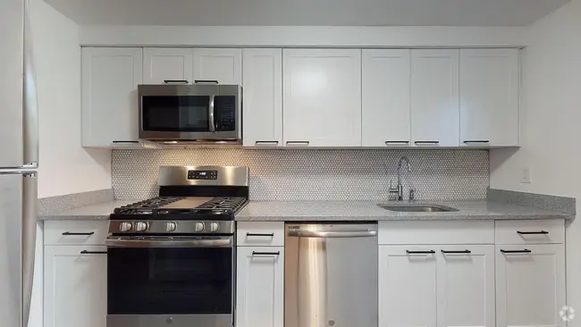 Completely renovated kitchen with modern stainless steel appliances, and quartz countertops - 31 Marylea Ave Rental