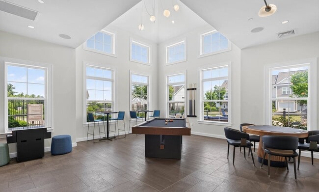 Windows on three sides look out to the pool deck and the townhomes beyond.