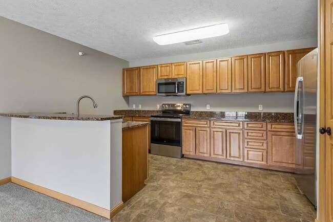 Bring your favorite recipes to life in this spacious kitchen featuring abundant cabinetry and an open design made for easy entertaining.