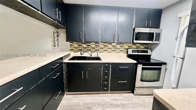 Building Photo - 7610 Stirling Rd Unit 103B