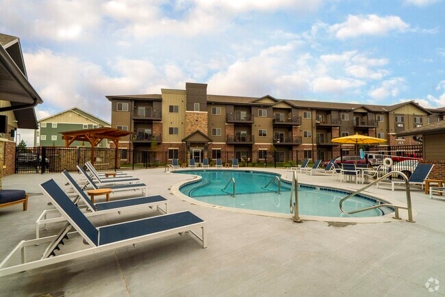Our resort-style pool area has plenty of seating, perfect for enjoying a relaxing day outdoors. - WH Flats Rental