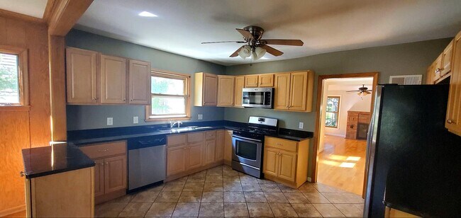 Additional kitchen view highlighting workspace and storage. - 2923 Arthur St NE