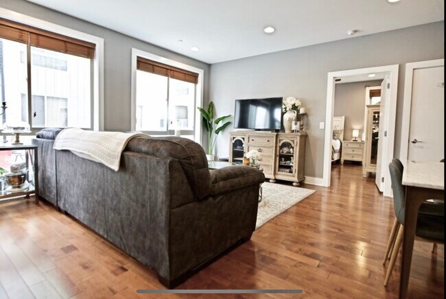 Floor to ceiling windows the entire one side of the unit for amazing natural light. - 1535 North Philip Street Unit GatedwithParkinghugePatio