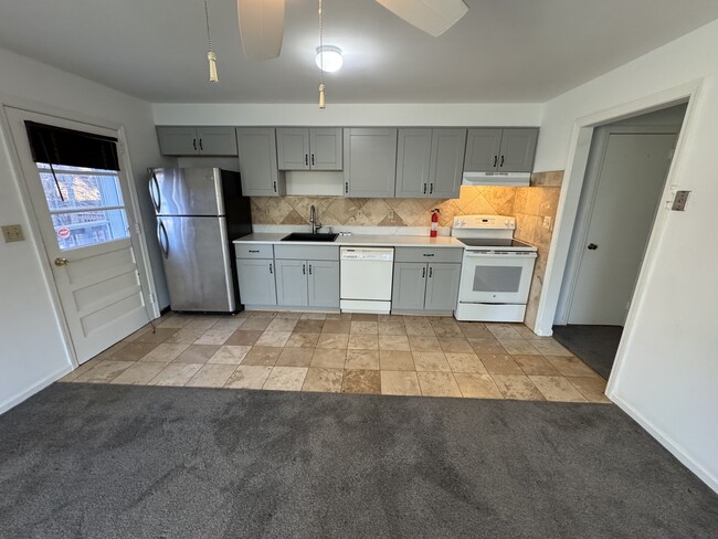 New Kitchen with Quartz Countertop & Tile Floor - 16 Oenoke Plz Apartments