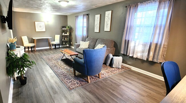 Living room with dining table and dedicated workspace - 1900 North St Apartments Unit C