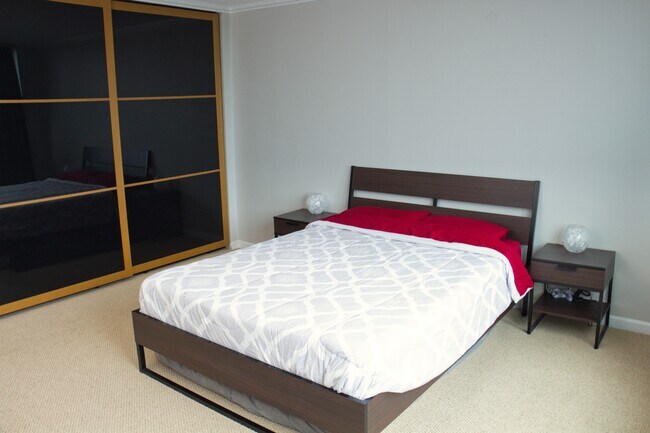Spacious bedroom with built out California closets - 4540 8th Ave NE Unit 1204