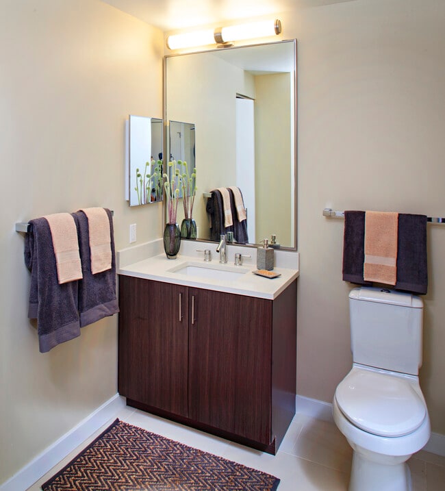 Classic Package I bathroom with espresso cabinetry, white quartz countertops, and hard surface flooring