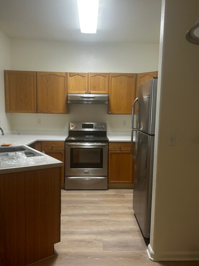 Kitchen w/stainless steel appliances - 7454 S Alkire St Unit 103