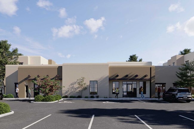 Oficina de arrendamiento y entrada a la comunidad de Cresta Ranch Apartments en Santa Fe, Nuevo México, con jardines de inspiración desértica y estacionamiento para residentes.