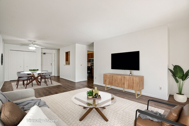 Enjoy comfortable living areas with space for seating and wall-mounted TV entertainment (virtually staged), professionally operated by Highlands Vista Group.