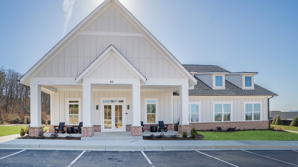 Clubhouse exterior with ample parking for future residents and visitors.