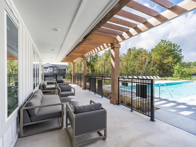 Our poolside seating offers the perfect spot to relax, recharge, and enjoy the serene atmosphere. - Beckett West Fork Apartments