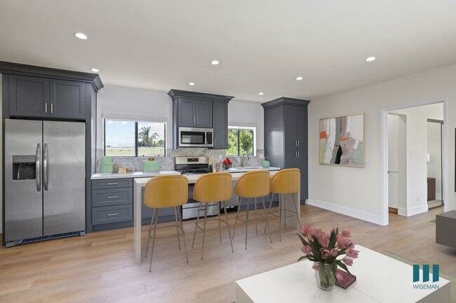 Open-Concept Kitchen Energy-Efficient Appliances and with Countertop Island Bar - Penmar Superba by Wiseman