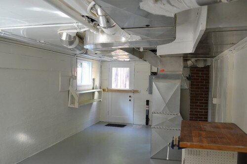 Large utility room has washer dryer, storage and backyard access