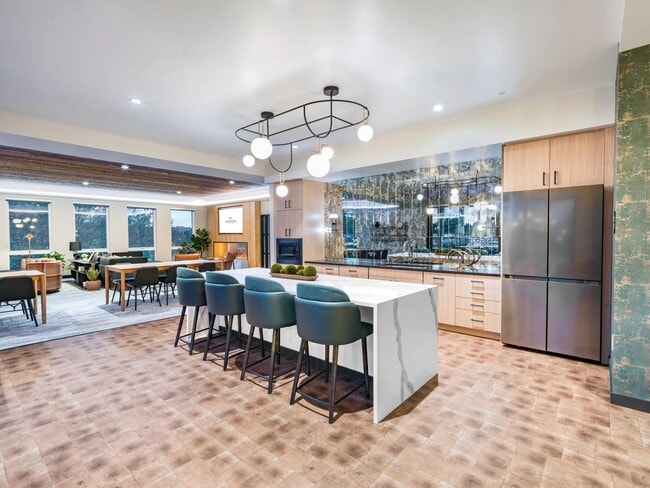 A vibrant lounge with space to gather and a kitchen perfect for cooking demos.