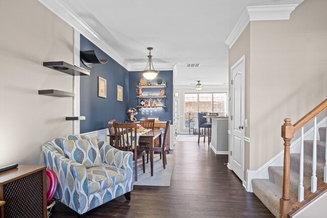 Photo - This inviting two-level townhome offers comfort and style, featuring gleaming hardwood floors on ...