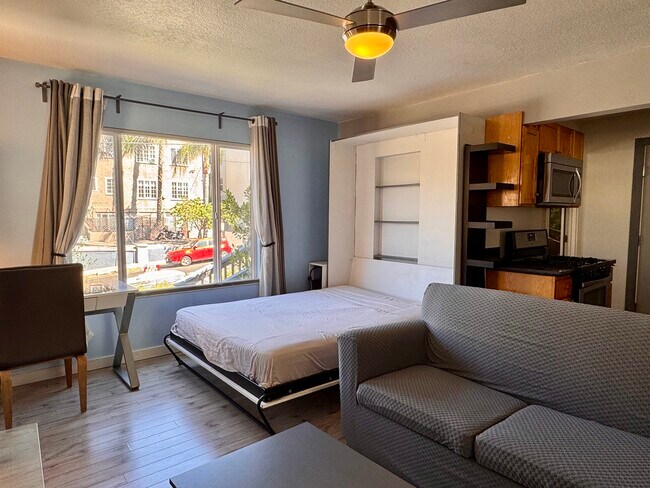 New couch cover (still a pull out sofa bed) - photo taken May 21 2025. More new photos soon! - 1045 1/2 Sanborn Ave