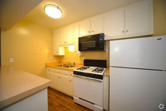 Ponderosa Apartments kitchen area with appliances - Ponderosa Apartments