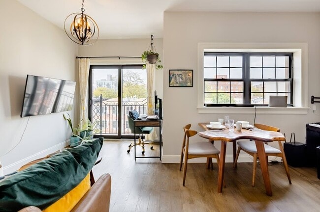 L-shaped layout fits a home office, living, and dining room with tallest-tower city views. - 504 Maple St Unit 4