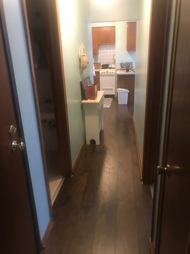 Hallway wit hardwood floors - 390 57th Pl NE Unit 2