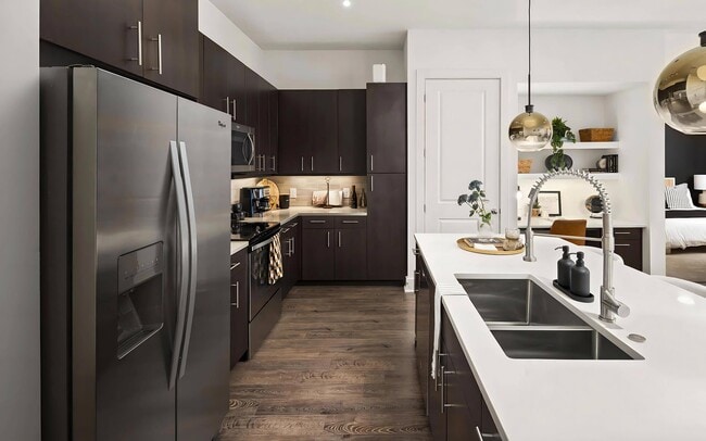 Stylish Kitchen with Stainless Steel Appliances and Dark Wood Cabinetry