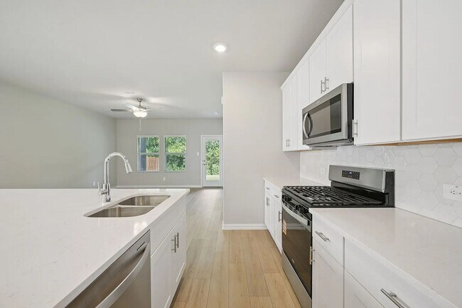 Photo - Stylish 3-bedroom home with modern kitchen, airy living spaces, vaulted primary suite, and elegan...