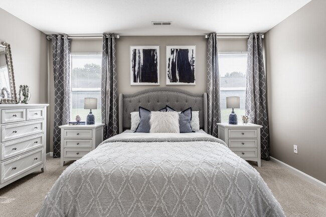 Step into a serene bedroom filled with natural light and thoughtful design, offering a comfortable and functional space to unwind.