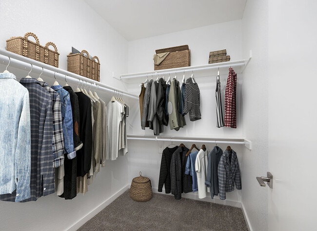 Explore this beautifully arranged walk-in closet, perfect for fashion enthusiasts.
