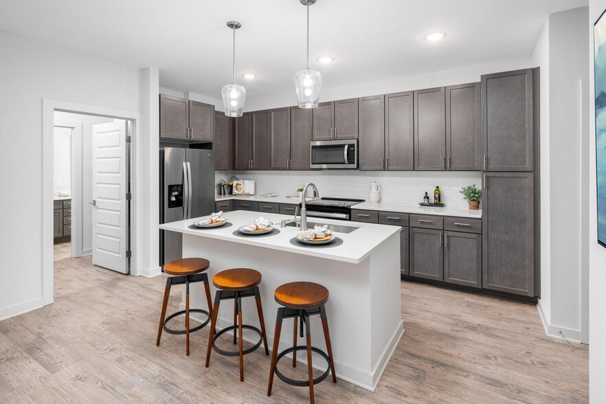Model Kitchen with Espresso Cabinetry and Stainless Steel Appliances