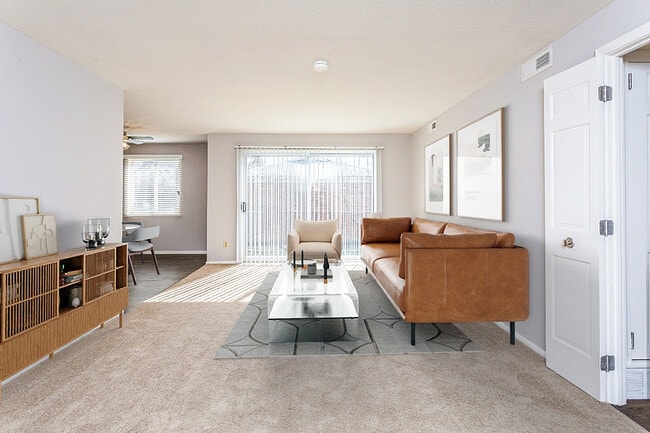 Large living room and dining room with sliding door to balcony or terrace - Village at Mayfield