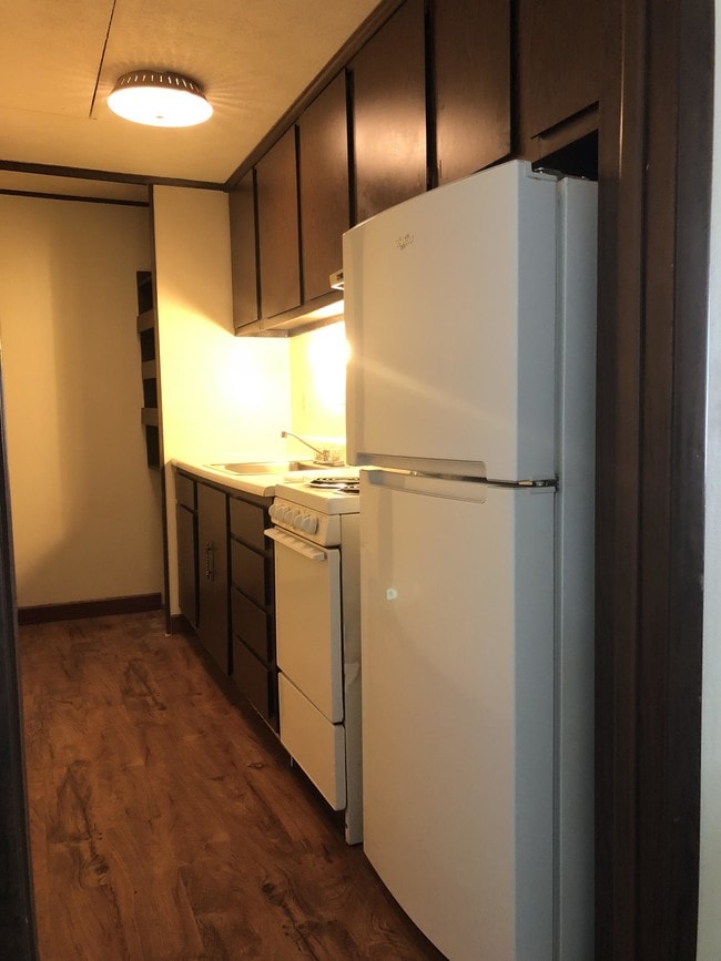 Galley kitchen with pantry - Pinewood Court Apartments