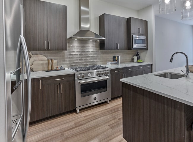 Experience elegance in this penthouse with upgraded kitchen appliances, including 36" Bertazzoni range, designed for style and functionality.