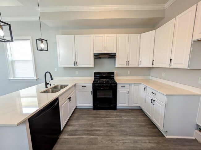 Kitchen with loads of cabinet space, quartz countertops, refrigerator, and gas oven/range - 1941 Casa Calvo St