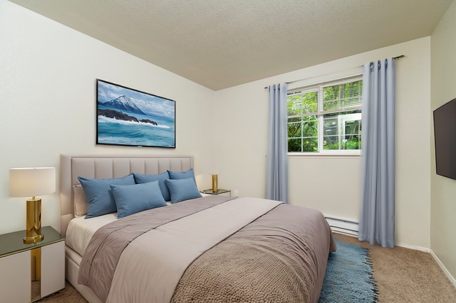 Experience tranquility in this elegantly designed bedroom, perfect for restful nights. - Sunset Gardens Apartments