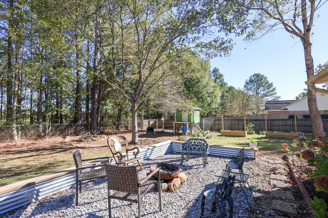 Includes chicken coop, raised garden beds, and fire pit area. - 15 Caitlin Ave