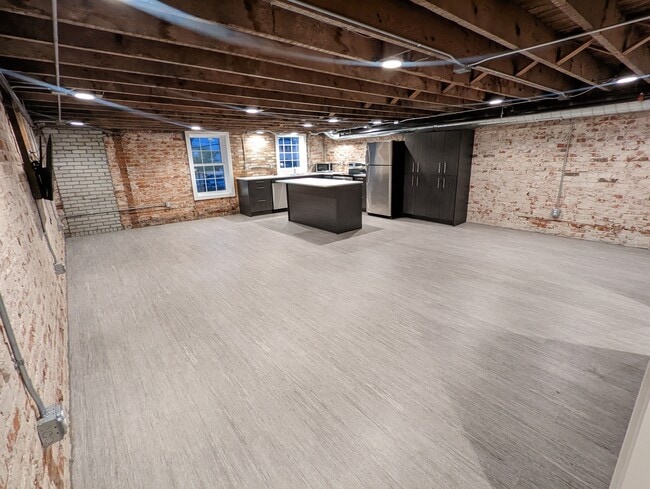 A view of the open concept kitchen/dining/living area. Photo may not be exact. - 130 E State St Apartments Unit 202