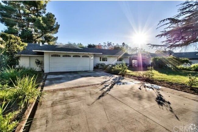 Charming mid-century brick home with inviting curb appeal, mature trees, and a spacious front yard - 332 E Deodar St Rental