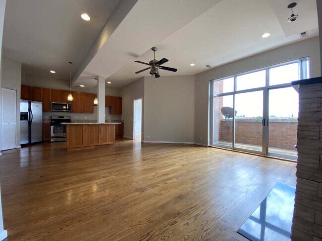 Breathtaking living space with hardwood floors and floor to ceiling windows