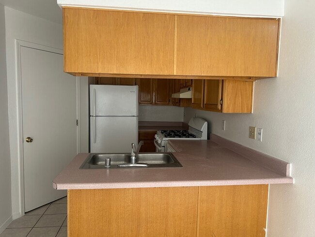 Kitchen with refrigerator, stove and dish washer. Hookups for laundry - 1345 Trudy Elaine Dr Unit C